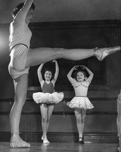 Two young girls practise ballet