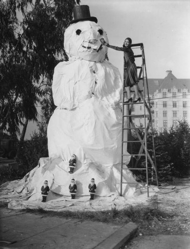 Young woman with Frosty the snowman, view 1