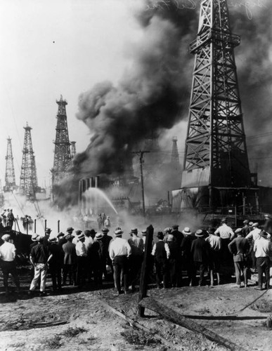 Onlookers watch oil field fire