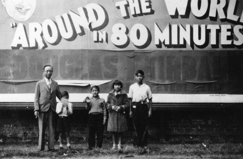 Chinese American children in front of billboard