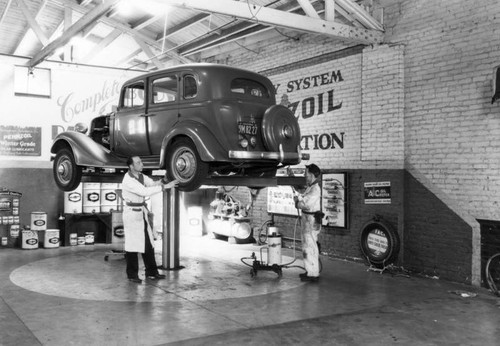 Mechanics work on an automobile