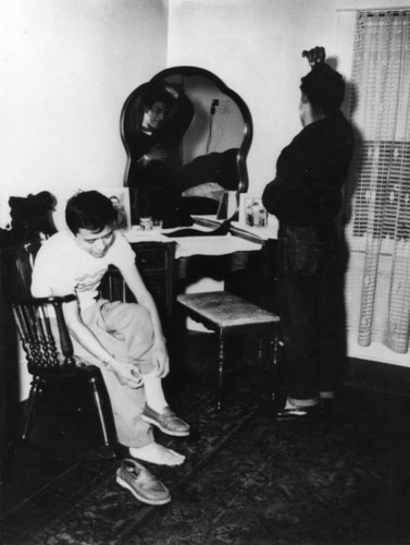 Navajo boys dressing and combing hair