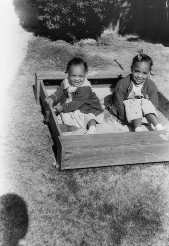 Two girls in sandbox
