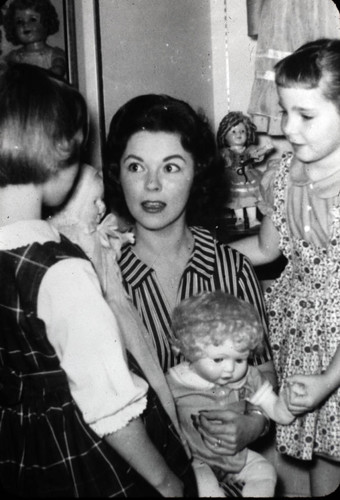 Shirley Temple-Black holds one of the dolls in her collection while greeting young fans