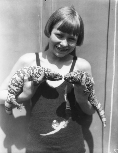 Girl holding gila monsters