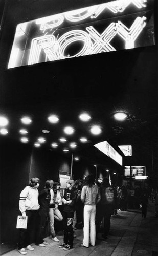 Rock fans wait outside the Roxy