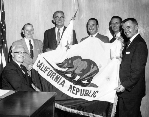 Chamber gifts Hiestand with flag