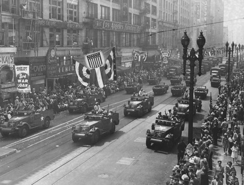 Military vehicles roll down Broadway