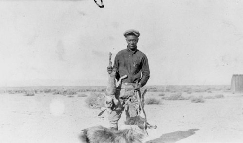 Hunter with rabbits