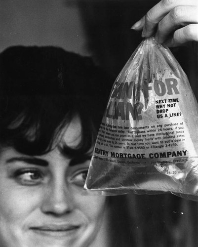 Mayerene Barker gazes into plastic bag at live goldfish