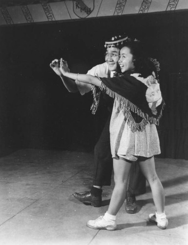 Japanese American couple dancing onstage