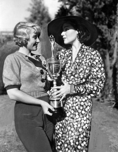 Dolores Del Rio and Joan Blondell holding WAMPAS trophy