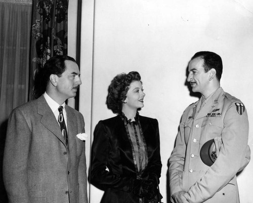 Myrna Loy congratulates officer