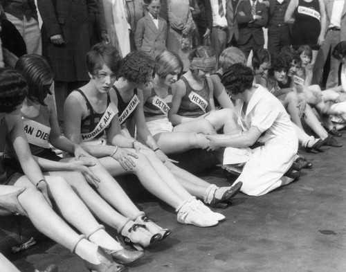 Marathon dancers sitting at curb