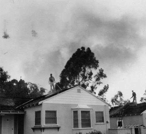 Smoke looms as roofs are soaked