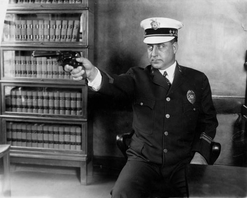 Chief Davis pointing his pistol