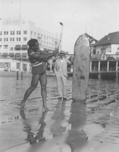 Duke Kahanamoku golfing on beach