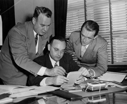 [District Attorney Edmund G. Brown (center) with Harry J. Neubarth (left) and unidentified man on right]