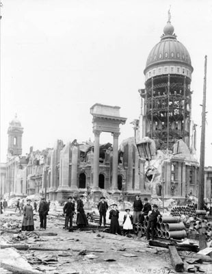 [Group of unidentified people posing in front of the ruins of City Hall after the 1906 earthquake and fire]