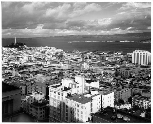 [View of downtown San Francisco showing Coit Tower on left and Treasure Island in distance]