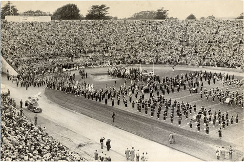 [Marching band playing the national anthem before an East-West Shrine football game at Kezar Stadium]