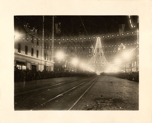 [Intersection of Market and Third streets, where 25,000 colored lights were suspended to form a gigantic bell, Portola Festival, October 19-23, 1909]