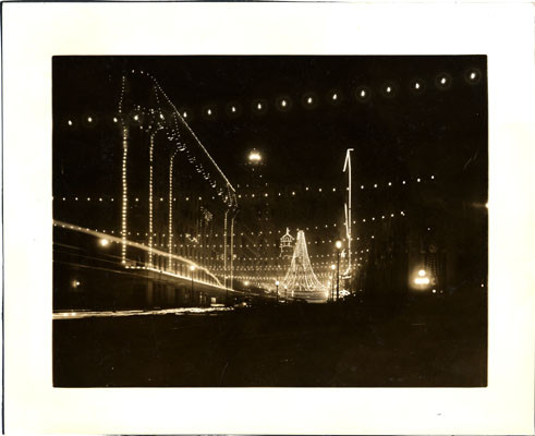 [Intersection of Market and Third streets, where 25,000 colored lights were suspended to form a gigantic bell, Portola Festival, October 19-23, 1909]