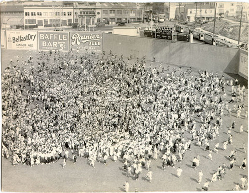 [Crowd of people on the field at Seals Stadium]