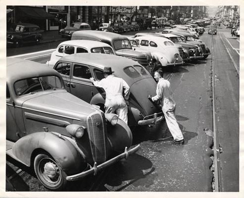 [Automobiles parked diagonally down the center of Market Street during streetcar strike]