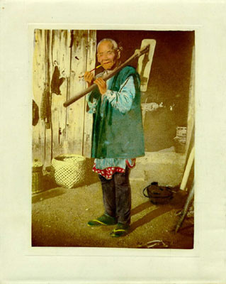 [Elderly Chinese man with gardener's tool in Chinatown]