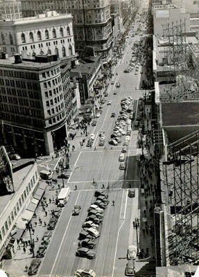 [Automobiles parked diagonally down the center of Market Street, near Mason]