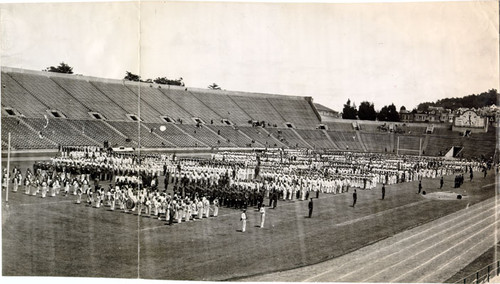 [Columns of uniformed people standing at attention on the field at Kezar Stadium]