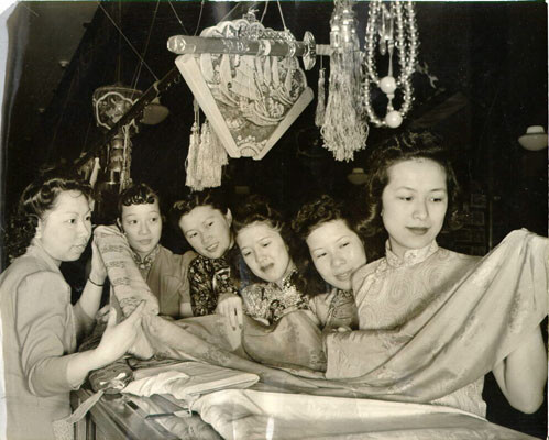 [Six women comparing fabrics to be worn in an annual benefit for St. Mary's Catholic Chinese Social Center]