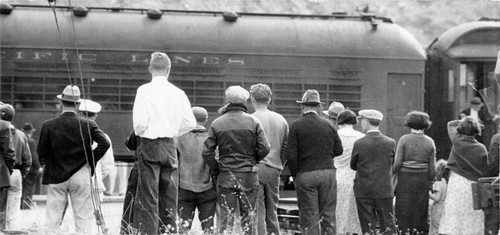 [Crowd watches as Alcatraz Island prison train departs with prisoners]