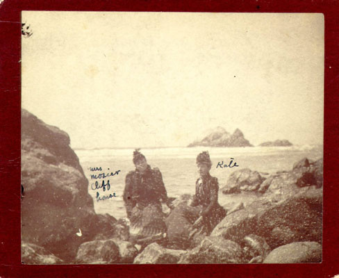 [Two women sitting on rocks at Ocean Beach]