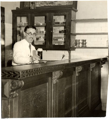 [Bartender serving a drink at the St. Francis Hotel bar]