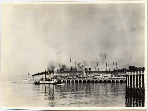 [Ships at docks near construction site of the Panama-Pacific International Exposition]