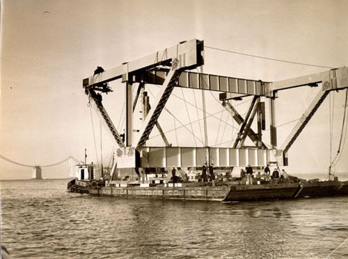 [View of workmen hanging steel for constructing San Francisco-Oakland Bay Bridge]