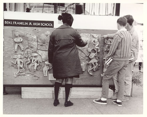 [Children pointing at relief art work belonging to Benjamin Franklin Junior High School]