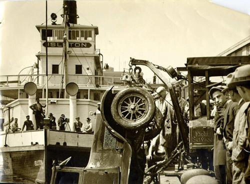 [Crowd of people gathered at China Basin to watch an automobile being recovered from the bay]