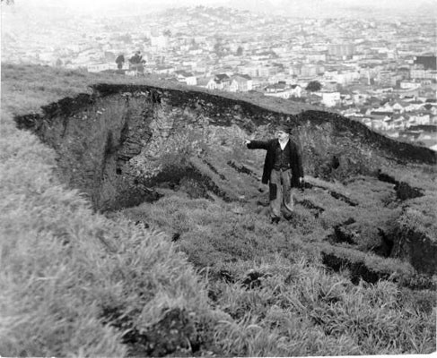 [Bernard Larsen standing at site of landslide on Bernal Heights hill]