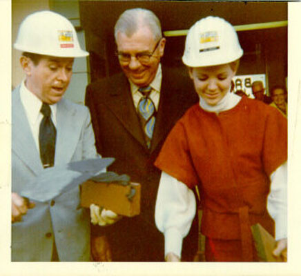 [Dennis Day, Sidney Haag and Dana Swenson standing in front of the Emporium department store on Market Street]