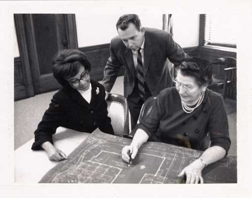 [People looking at architectural drawing of the Western Addition Branch Library]