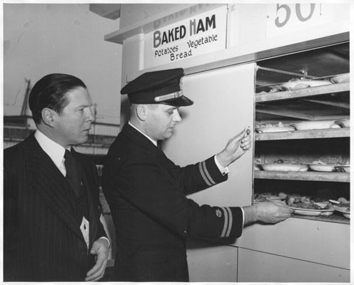 [William E. Broeg and Dr. Robert S. Goodhart inspecting the heated serving cabinets at Bethlehem Steel Company's San Francisco shipyard]