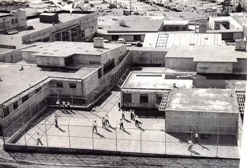 [Boys playing in an outdoor play area at the Youth Guidance Center]