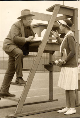 [Mexican artist Diego Rivera talking with Helen Wills on a tennis court]