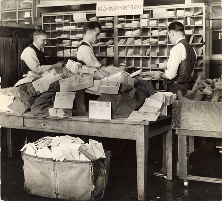 [Postal service employees working at the fast freight room in the Ferry station Post office]