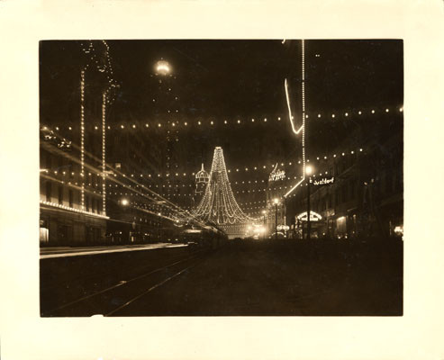 [Intersection of Market and Third streets, where 25,000 colored lights were suspended to form a gigantic bell, Portola Festival, October 19-23, 1909]