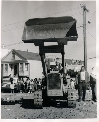 [Mayor Shelley operating machinery on the site for the Excelsior Library]