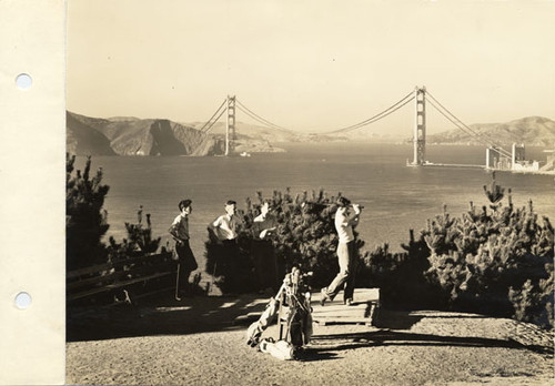 Golfers at Lincoln Park Golf Course, with view of partially